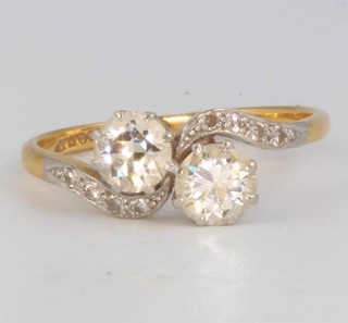 An Edwardian 18ct yellow gold 2 stone diamond crossover ring, each stone approx 0.6ct size Q 1/2