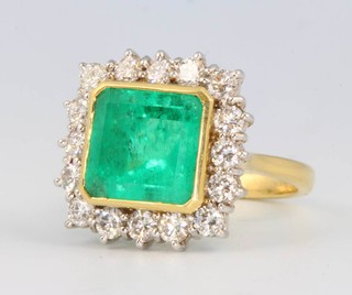 An 18ct white gold square cut emerald and diamond ring, the centre stone approx. 6.3ct, the brilliant cut diamonds approx. 1.6ct with EDR certificate, size L 