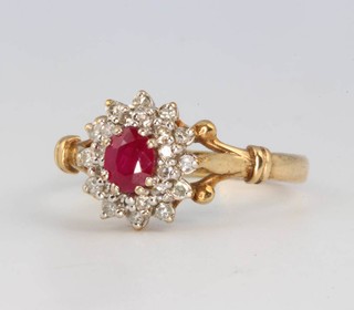 A 9ct yellow gold ruby and diamond cluster ring size Q
