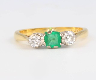 An 18ct yellow gold emerald and diamond ring size K 