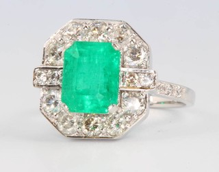 An 18ct white gold emerald and diamond cluster ring, the centre stone approx. 3.03ct surrounded by brilliant cut diamonds approx. 1.65ct size P 1/2
