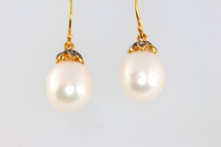 A pair of cultured pearl and diamond ear drops 