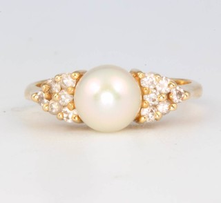 A 14ct yellow gold pearl and diamond ring size J 