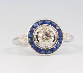 An 18ct white gold sapphire and diamond target ring, the centre diamond approx. 0.53ct size M 1/2 
