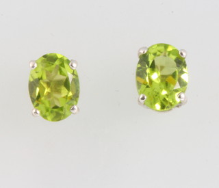 A pair of silver peridot ear studs 