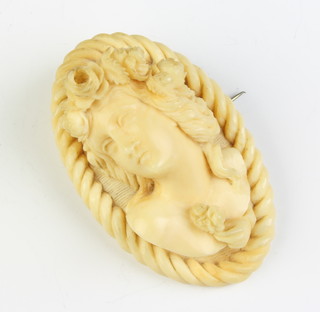 A Victorian carved ivory portrait brooch 