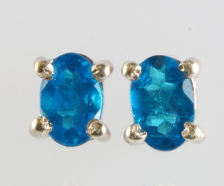 A pair of silver neon apatite ear studs 