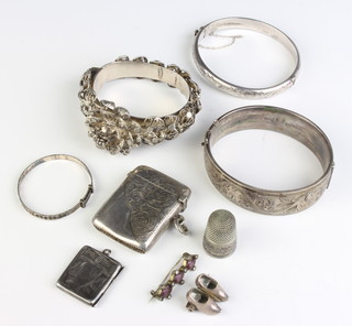 A silver chased bangle, 2 others and minor items including a vesta
