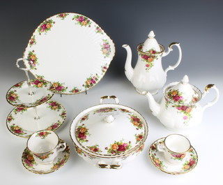 A Royal Albert Old Country Roses tea, coffee and dinner service comprising 12 tea cups, 14 saucers, 10 coffee cups, 9 saucers, 1 tea pot, 1 coffee pot, 2 milk jugs, 1 cream jug, 1 lidded sugar bowl, 10 dessert bowls, 5 two handled cups, 8 saucers, 11 small plates, 10 medium plates, 12 dinner plates, a 2 tier cake stand, 2 dishes, a platter, 2 tureens and covers, sauce boat and stand and 2 serving plates