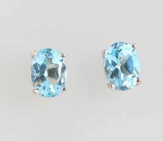 A pair of silver topaz studs