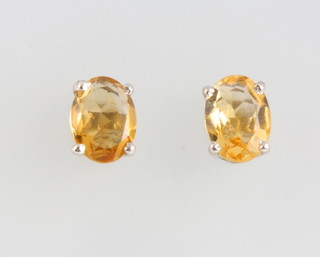 A pair of silver citrine ear studs