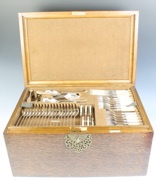 An oak canteen containing a matched quantity of plated cutlery for 12 with 5 interior fitted trays 