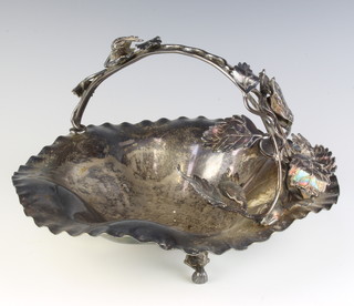 An Edwardian silver plated nut dish with nut and leaf scrolling handles on scroll feet 30cm 