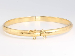 A yellow gold chased bangle 10.3 grams 