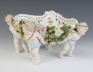 A Meissen style centrepiece with 4 angels holding aloft a pierced basket encrusted with flowers 33cm 
