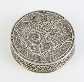 A Continental filigree circular silver box and cover decorated with a bird amongst leaves 105 grams