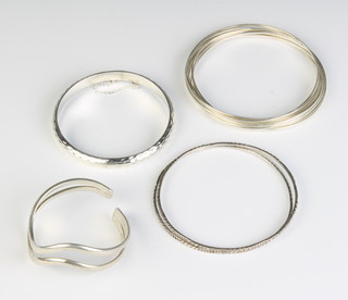 A silver bracelet and 3 bangles, 70 grams 