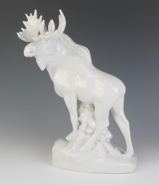 A Continental white glazed figure of a standing moose on a rocky outcrop 34cm 