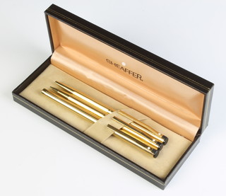 A Sheaffer gold plated fountain pen, ballpoint pen and pencil, cased 