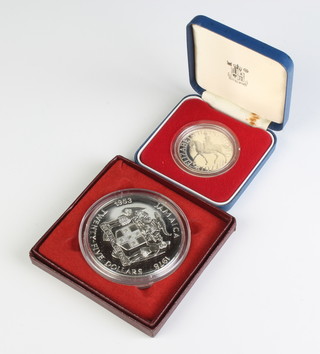 A silver Jamaica 25th Anniversary of the Coronation crown, 136 grams together with a ditto 1977 commemorative crown, both cased