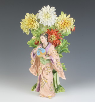 A German vase of a Japanese lady standing before chrysanthemums 30cm 