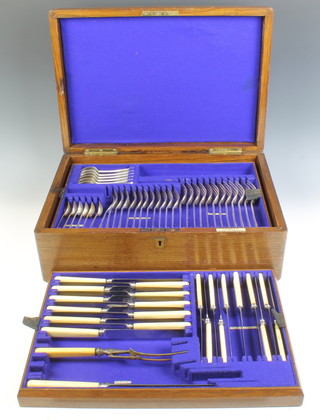 An Edwardian oak canteen containing a quantity of plated cutlery for 12