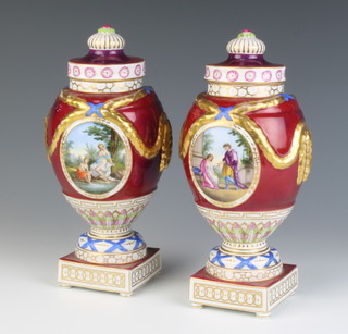 A pair of 20th Century Berlin style vases and covers, the burgundy and gilt ground with panels of figures raised on round feet 23cm 