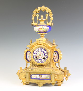 Japy Freres, a French 8 day striking mantel clock contained in a gilt painted spelter case with porcelain panels and Roman numerals, striking on a bell, the case surmounted by a lidded urn, the back plate marked 6388