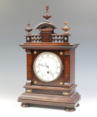A 19th Century Continental timepiece with enamelled dial and Roman numerals contained in a carved mahogany case, the back plate marked P.H & S