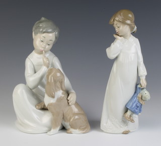 A Lladro figure of a seated boy with puppy 4522 19cm together with a Nao figure of a girl in her nightdress holding a toy clown 20cm 