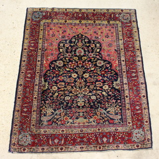 A Persian Tabriz rug with mihrab floral decoration and peacocks within a multi row border 180cm x 140cm