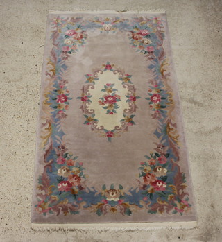 A cream and floral patterned Chinese rug with central medallion 220cm x 122cm (fringe reduced) 