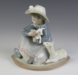 A Lladro group of a seated girl holding a lamb with a sheep at her feet 5469 14cm 