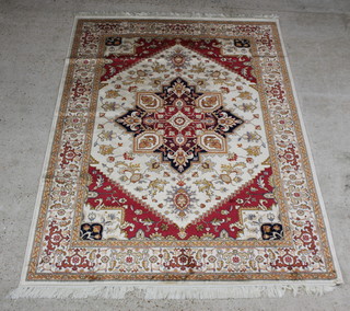 A gold and tan ground Heriz Belgian cotton carpet with central medallion within a multi row border 230cm x 160cm 