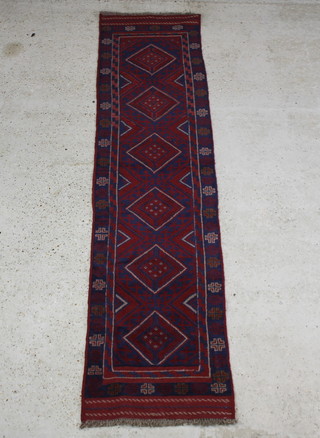 A red and blue ground Meshwani runner with 6 diamonds to the centre within a multi row border 265cm x 61cm 