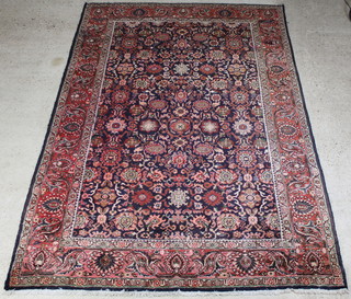 A blue and red floral patterned Persian carpet 324cm x 228cm 