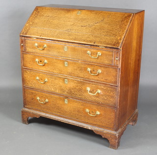 A George III oak bureau, the fall front revealing a fitted interior above 4 long graduated drawers with brass escutcheons and swan neck drop handles raised on bracket feet 107cm h x 94cm w x 52cm d 