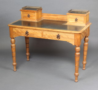 A Victorian bleached mahogany aesthetic movement writing table, the upper section fitted 2 stationery boxes with brass 3/4 gallery and fitted a drawer, the base with 2 long drawers and raised on turned supports 94cm h x 112cm w x 54cm d 