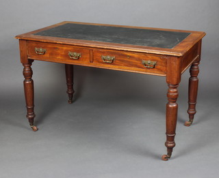 A Victorian mahogany writing table with inset writing surface, fitted 2 drawers with brass swan neck drop handles, raised on a turned column with brass caps and casters 74cm h x 122cm w x 67cm d  
