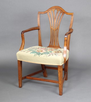 A 19th Century mahogany Hepplewhite style open arm carver chair with Berlin woolwork overstuffed seat raised on square tapered supports with H framed stretcher