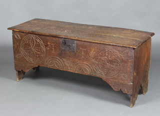 A 17th/18th Century coffer of panelled construction with iron lock front and hinged lid, the front carved and marked "I T" 51cm h x 122cm w x 43cm d 