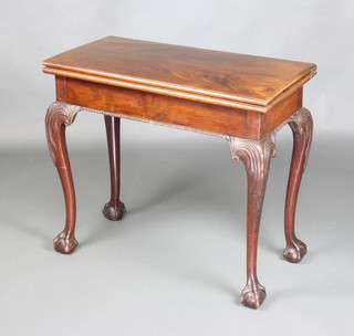 A Chippendale style mahogany card table raised on carved cabriole supports 72cm h x 81cm w x 40cm d 
