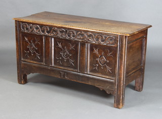 A 17th/18th Century oak coffer of panelled construction with hinged lid, the interior fitted a candle box 65cm h x 117cm w x 51cm d 
