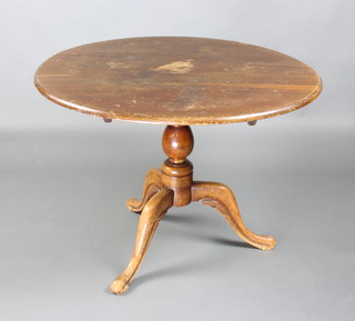 A Victorian circular beech and mahogany snap top tea table raised on a turned column 70cm x 97cm diam. 