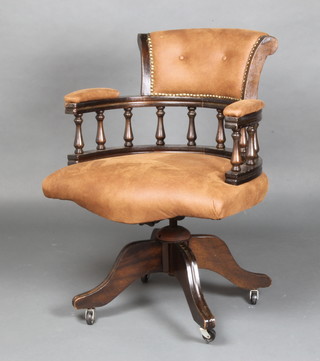 A tub back "Captains" revolving office chair with spindle decoration, upholstered in "suede" material  