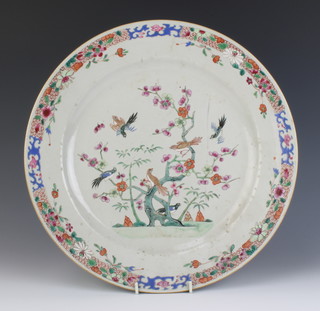 An 18th Century Chinese famille rose plate decorated with exotic birds amongst branches of a flowering tree enclosed in a floral border 35cm 