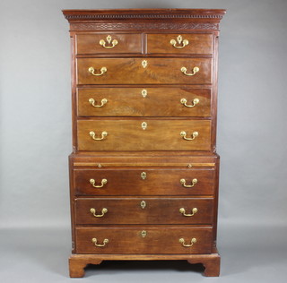 A Georgian mahogany chest on chest with moulded and dentil cornice, blind fret work frieze and canted corners, the upper section fitted 2 short drawers above 3 long drawers, the base fitted a brushing slide above 3 long drawers, raised on bracket feet 180cm h x 104cm w x 52cm d 