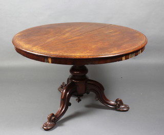A Victorian circular snap top dining table raised on a turned column and tripod base 70cm h x 116cm diam. 