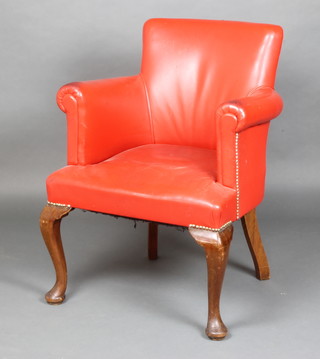 A Georgian style tub back armchair upholstered in red leather, raised on cabriole supports 