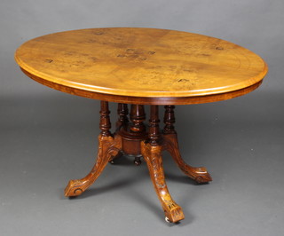 A Victorian oval inlaid walnut Loo table raised on 4 columns and tripod base 72cm h x 118cm w x 87cm d. 